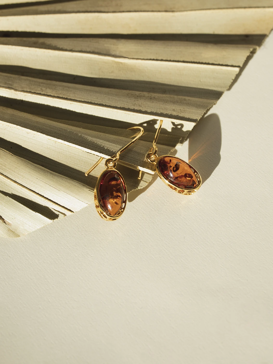 Thumbnail of Harmony gold earrings with cognac amber