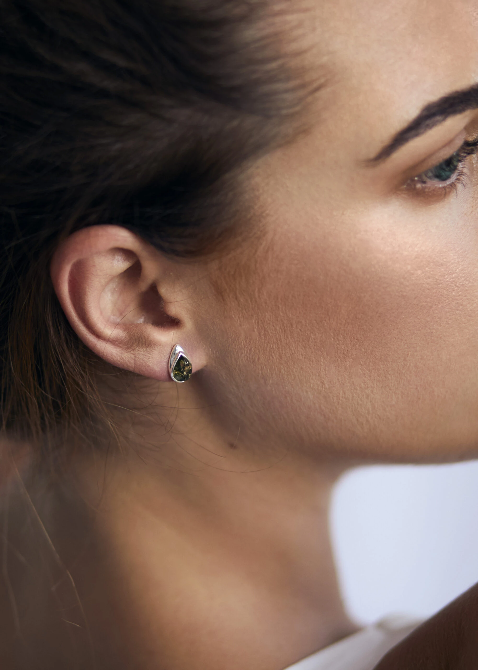 Silver stud earrings with green amber