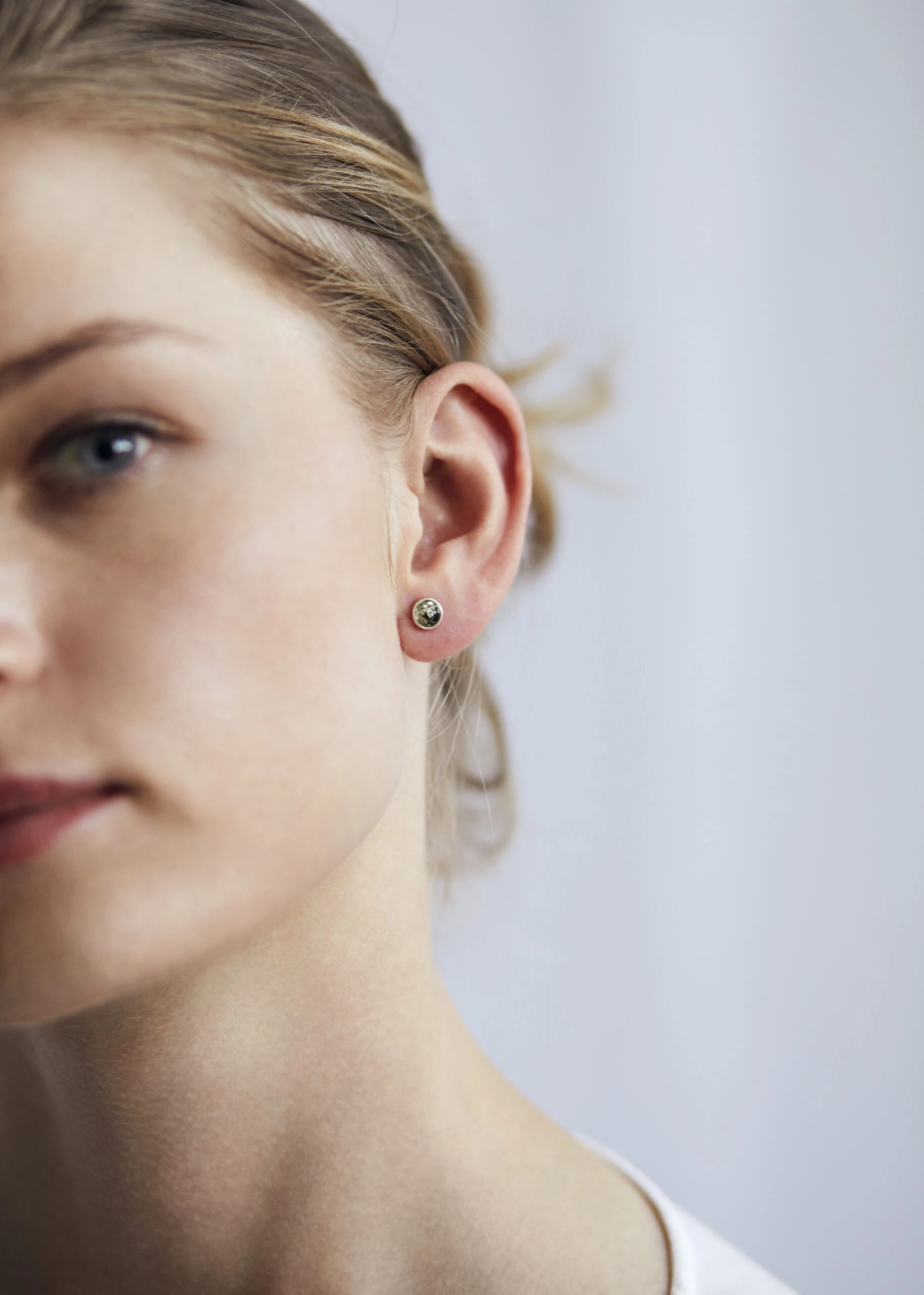 Silver stud earrings with green amber