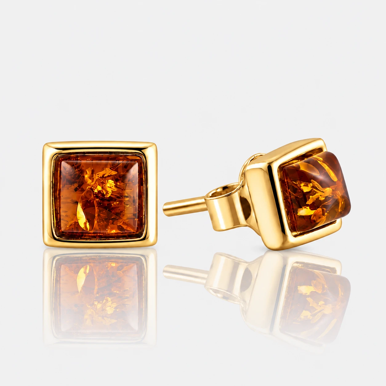Square, petite gold earrings with cognac amber