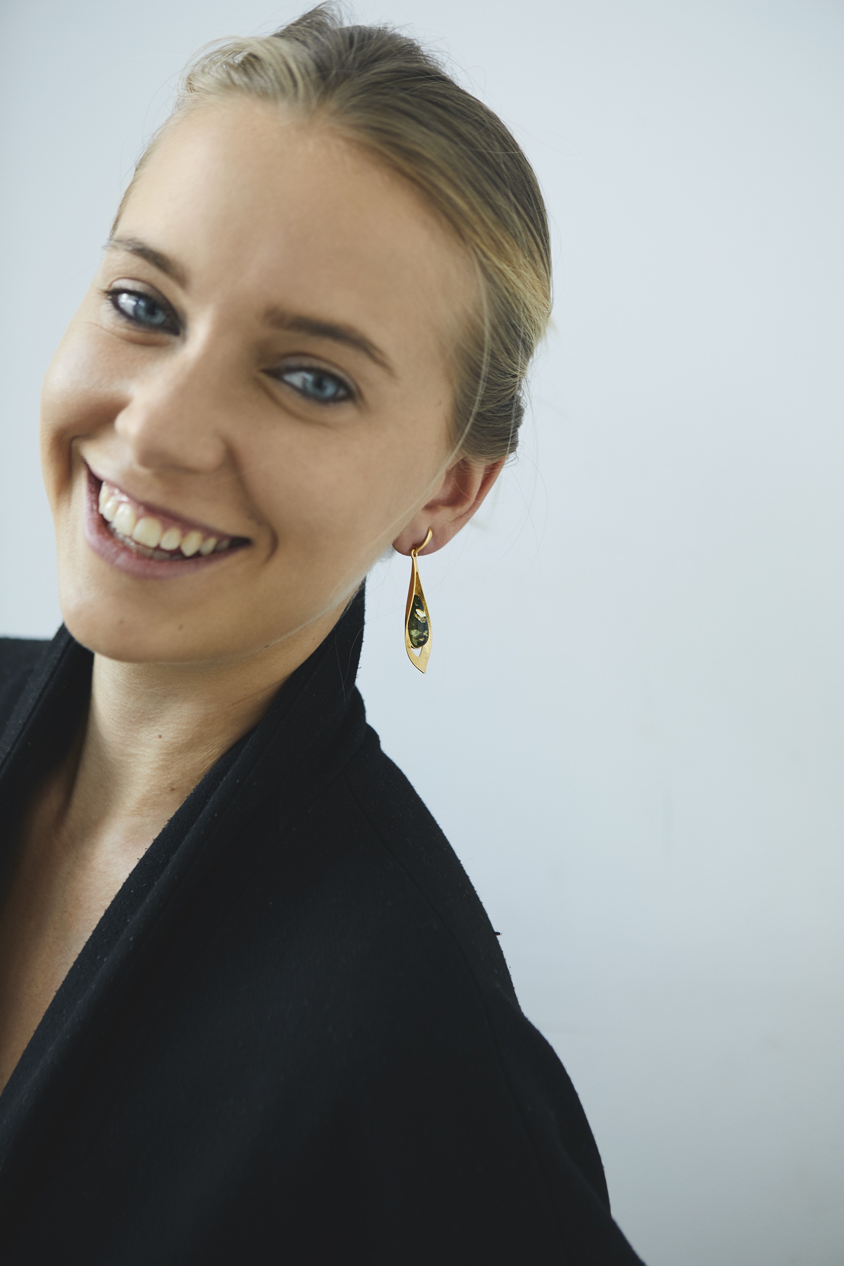 Long gold earrings with green amber